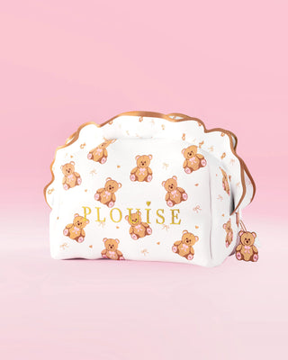 Une grande trousse de maquillage et de soin à imprimé ours en peluche P.Louise avec un motif volant sur fond rose