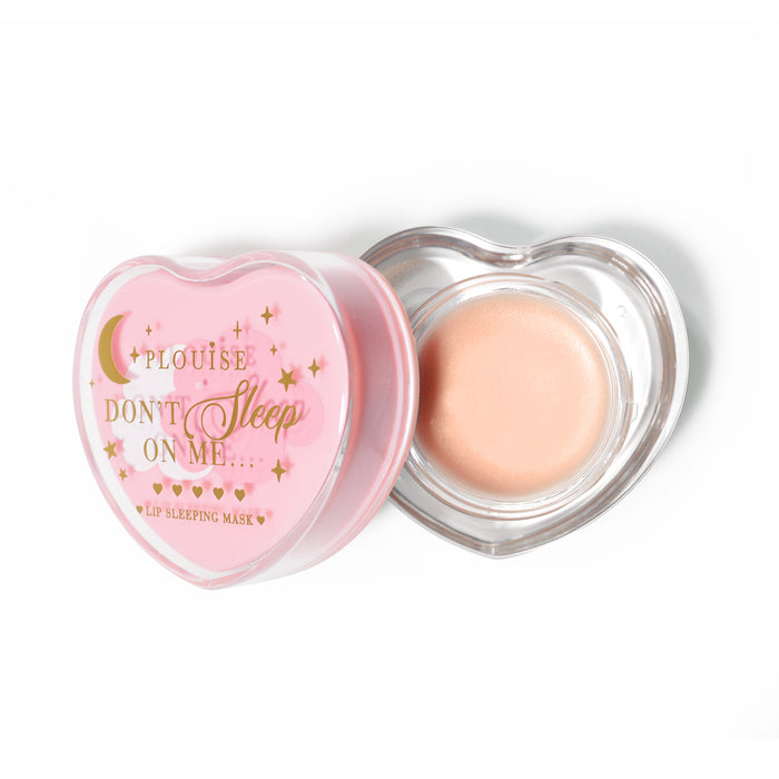Roze hartvormig lipslaapmasker met het deksel eraf op een witte achtergrond
